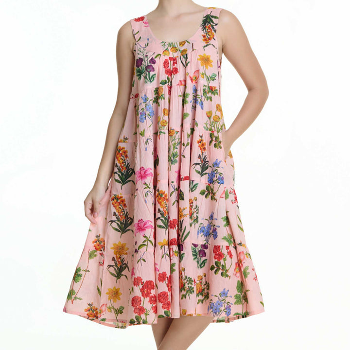 Front view of model in pink floral nightie with scooped neckline and pockets