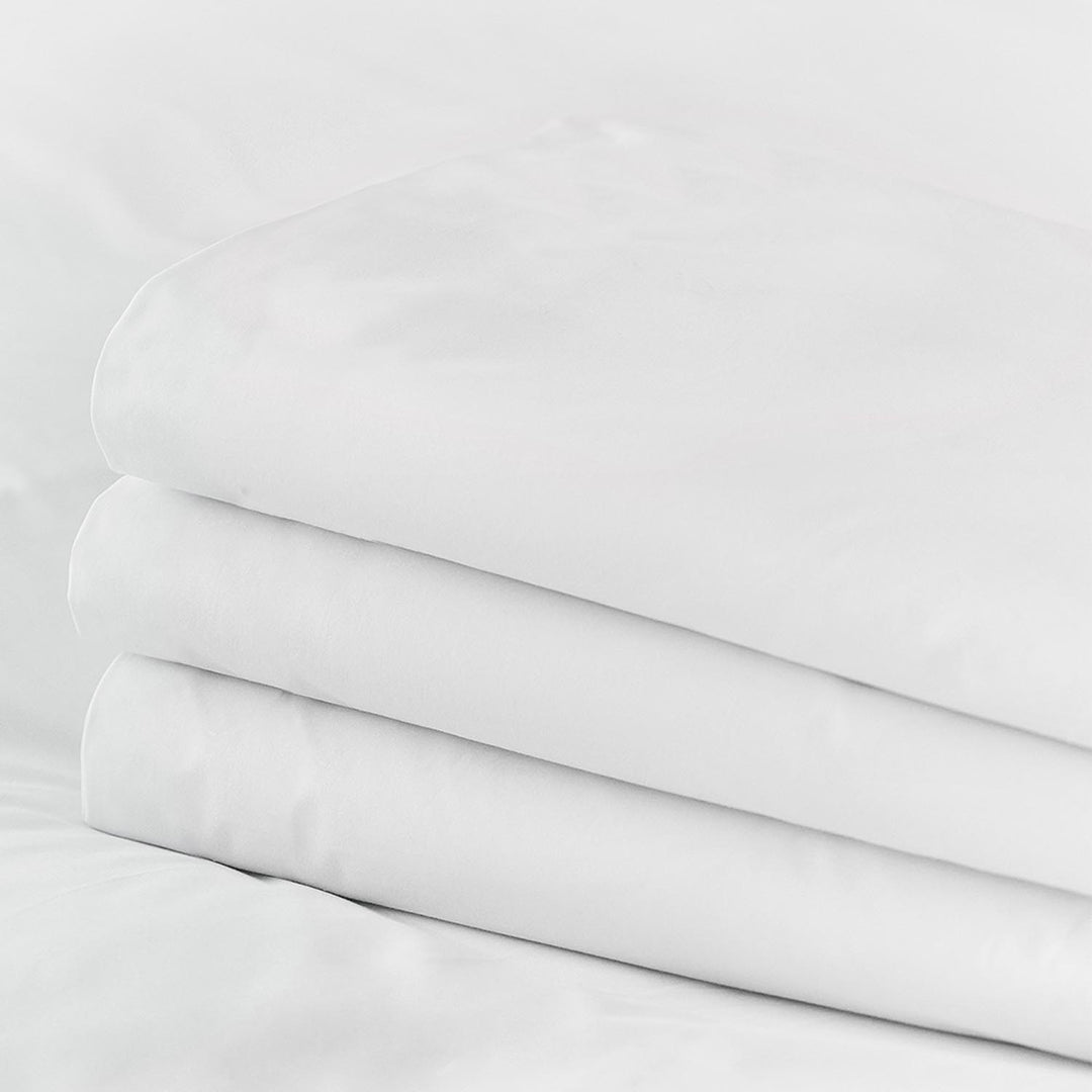 Stack of pure white Egyptian cotton fitted top sheets