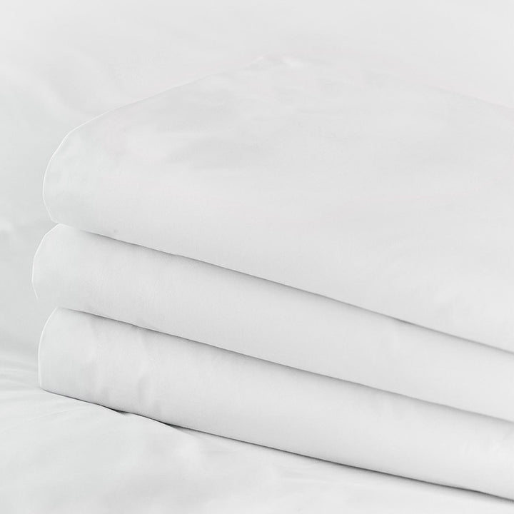 Stack of pure white Egyptian cotton fitted top sheets