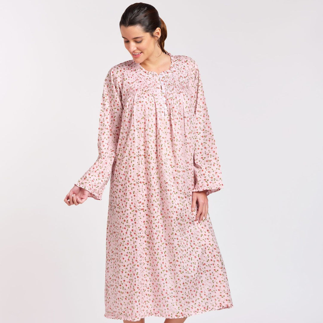 Woman wearing the Rosie Long Sleeve Nightie in pink rosebud cotton, featuring long sleeves, a pleated bodice, and mid-calf length – perfect for cooler nights.