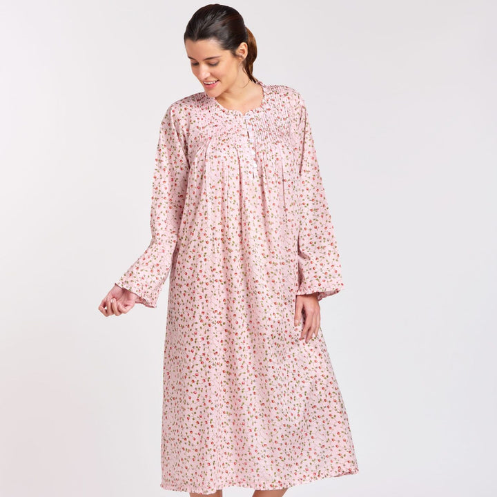Woman wearing the Rosie Long Sleeve Nightie in pink rosebud cotton, featuring long sleeves, a pleated bodice, and mid-calf length – perfect for cooler nights.