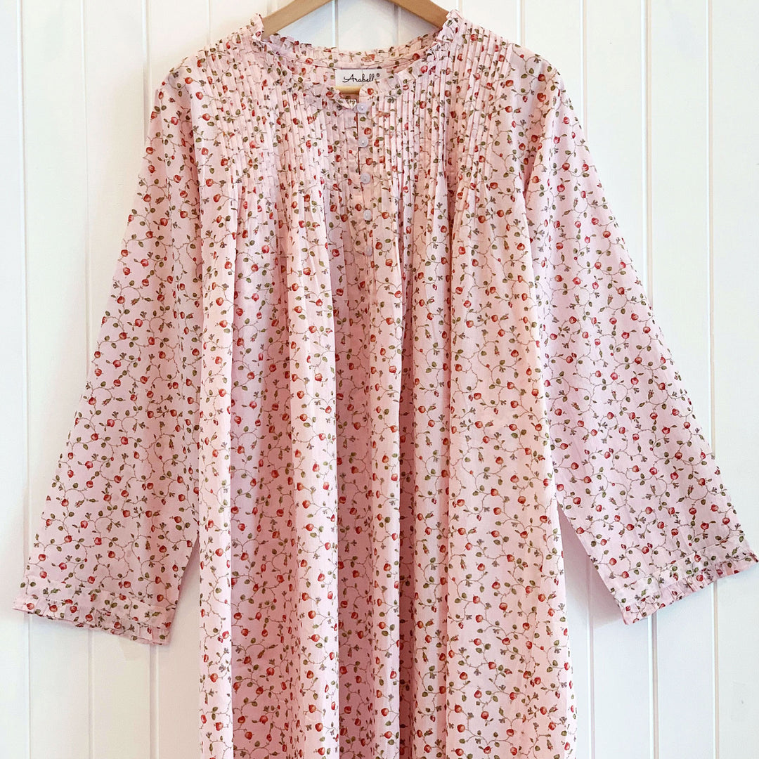 Rosie Long Sleeve Nightie in pink rosebud cotton, displayed on a hanger to show detailed pleating and floral pattern.