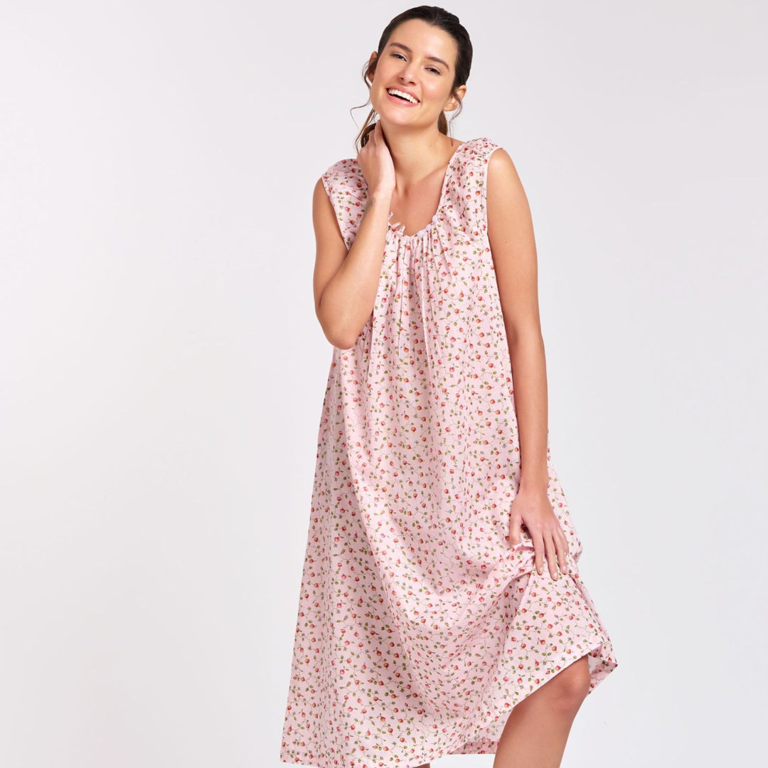 oman wearing pink rosebud print cotton nightie with cap sleeves, standing and smiling