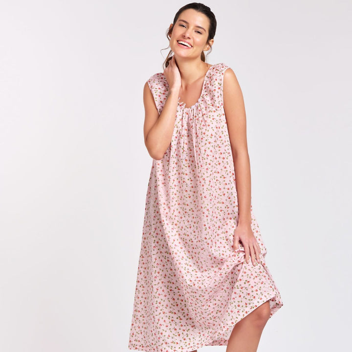 oman wearing pink rosebud print cotton nightie with cap sleeves, standing and smiling
