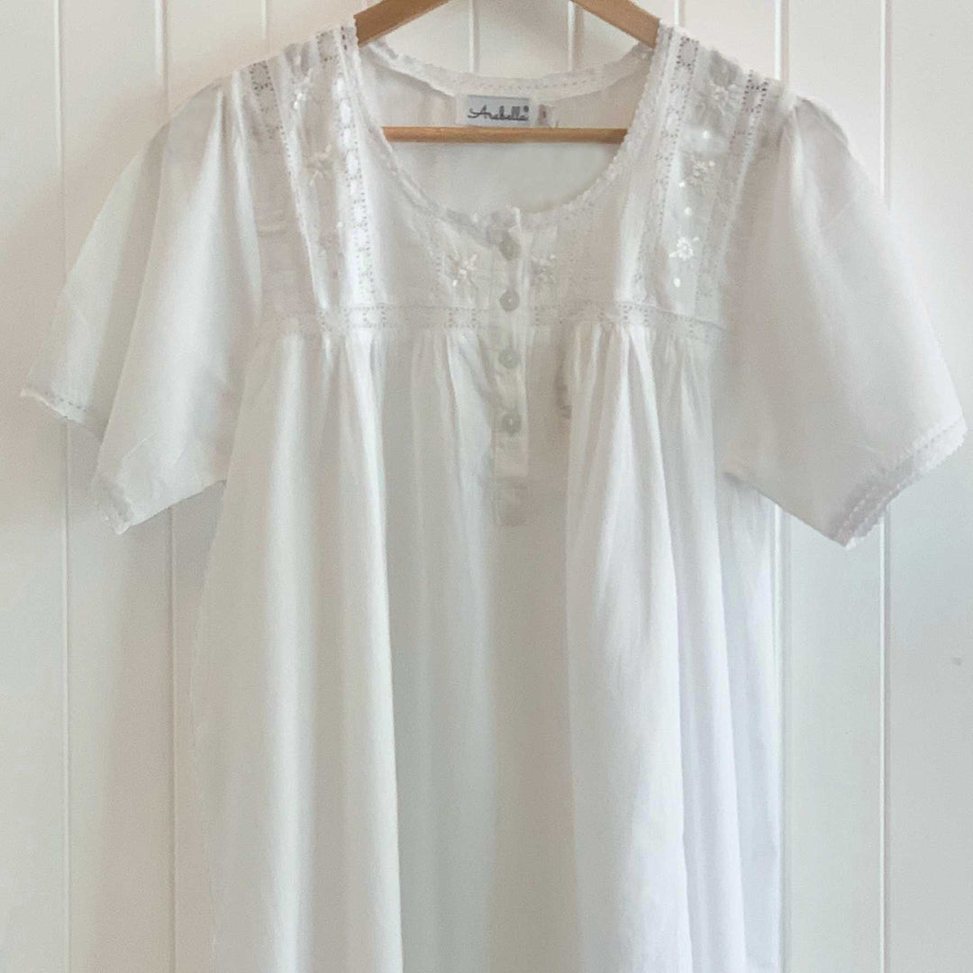 White cotton short sleeve nightie with lace trim on hanger