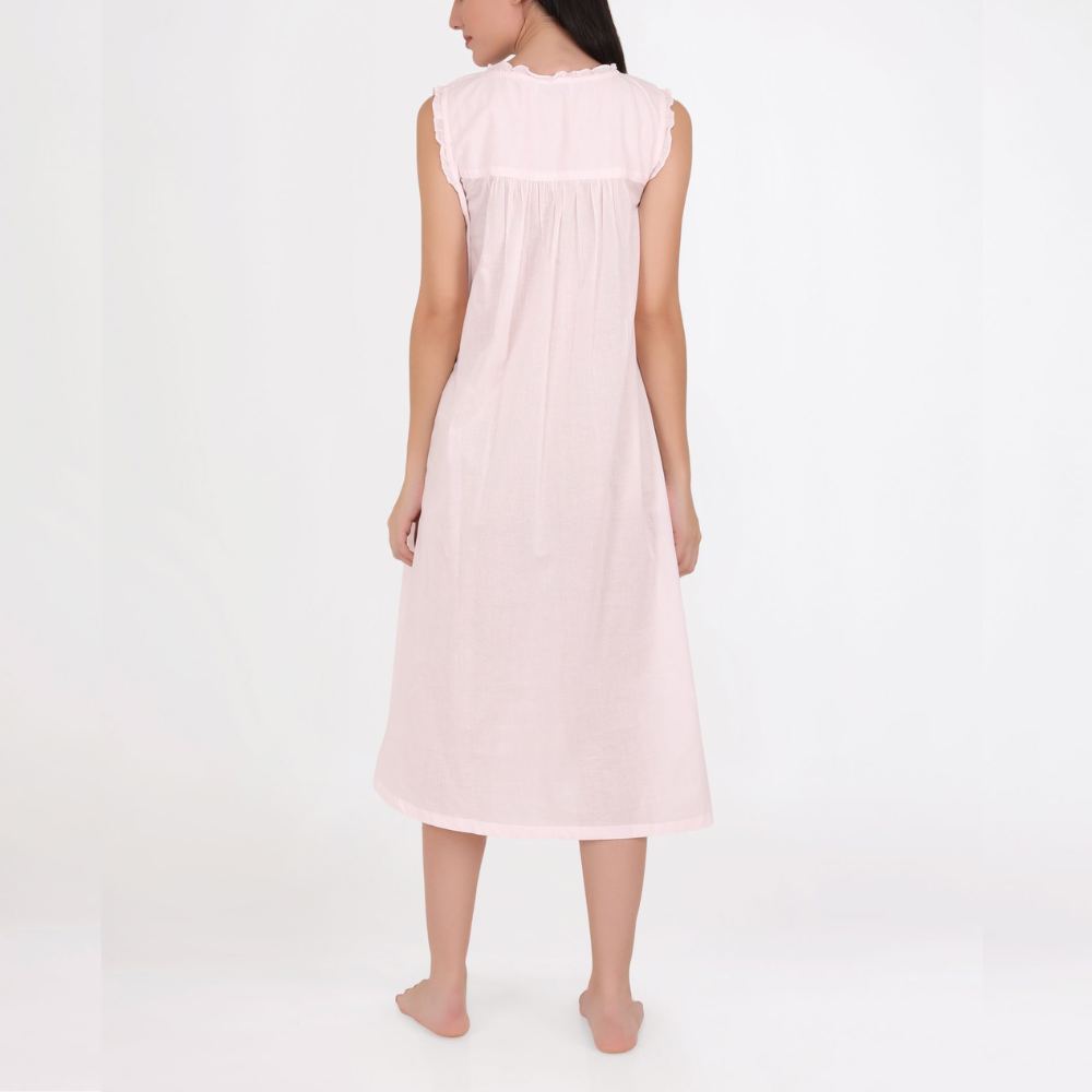 Woman wearing a light pink sleeveless dress on a white background