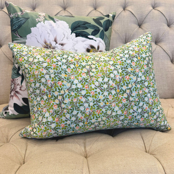 Floral patterned pillows on a beige sofa