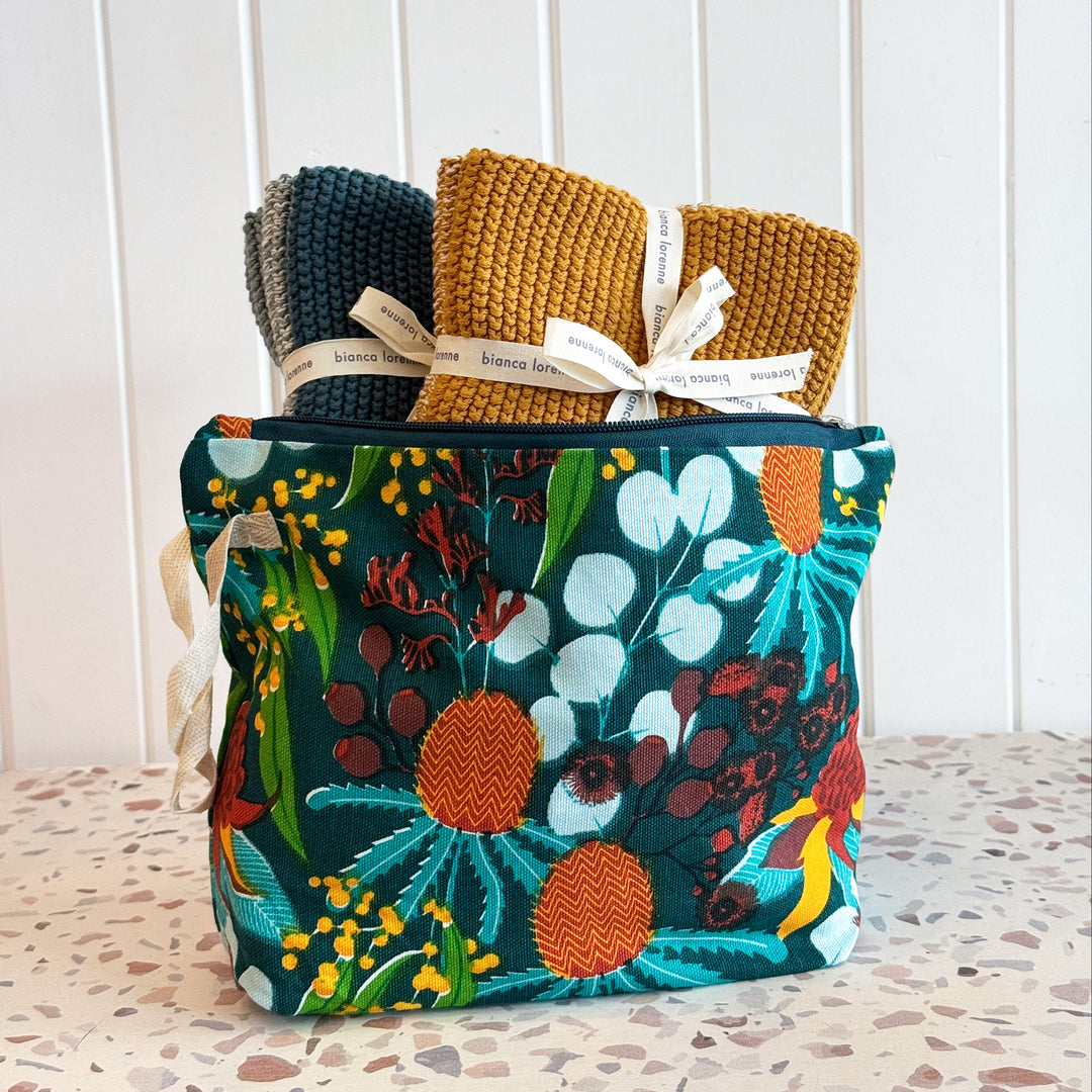 Floral-patterned pouch with knit items on a textured surface
